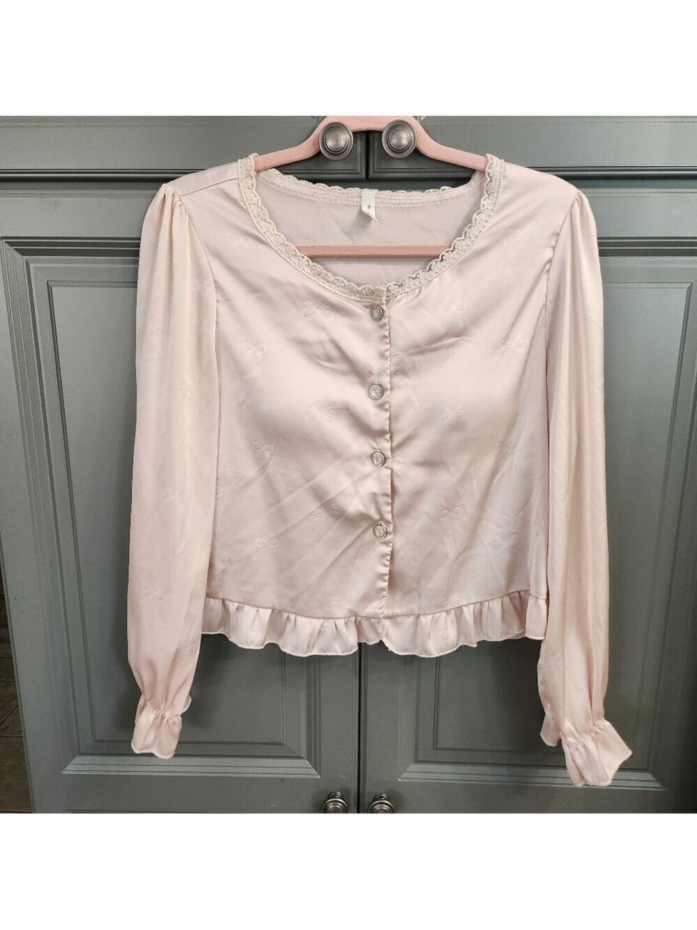Women's satin, pink pajama top ,lace trim buttoned down, bow print.